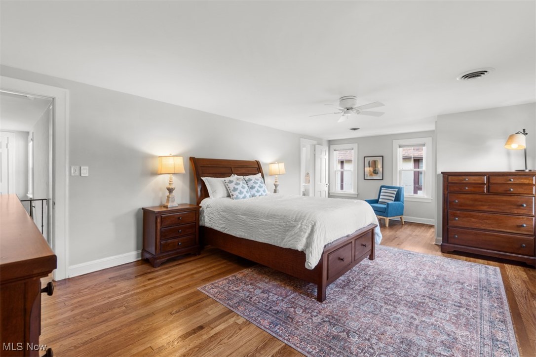 3124 Warrington Road Cleveland, OH 44120 - Photo 18 of 36 Bedroom featuring wood finished floors, visible vents, a ceiling fan, and baseboards