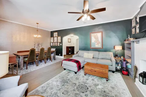 a living room with furniture kitchen view and a fireplace