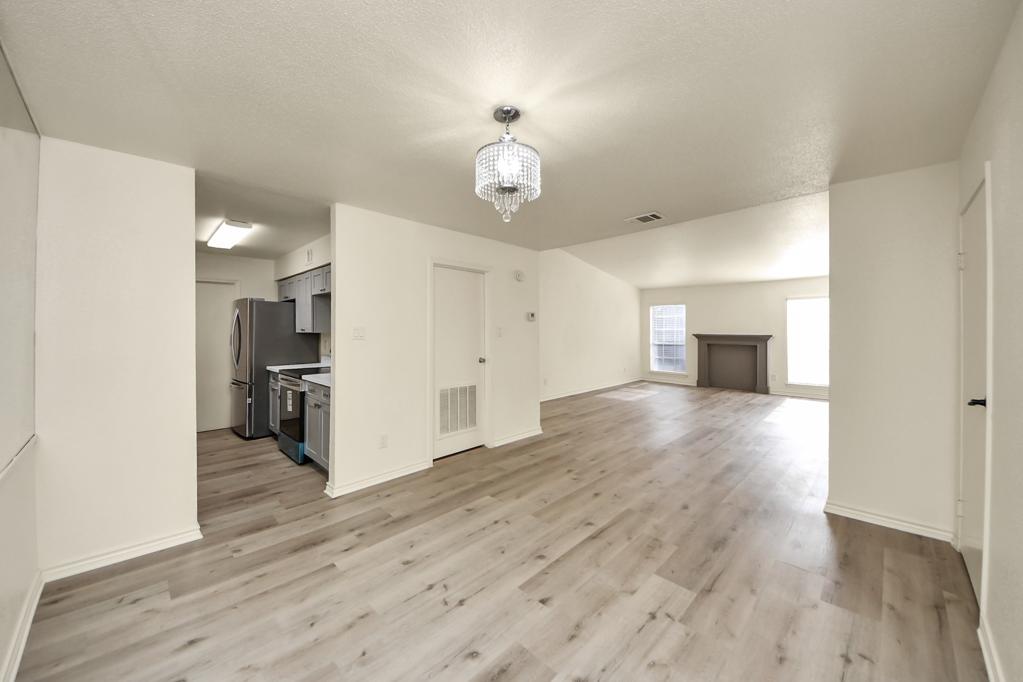 6500 Sands Point Drive, Unit 804 Houston, TX 77074 - Photo 1 of 40 a view of a kitchen with wooden floor and a ceiling fan
