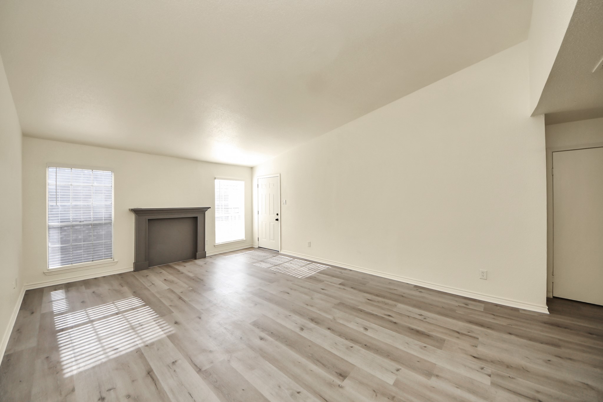 6500 Sands Point Drive, Unit 804 Houston, TX 77074 - Photo 12 of 40 an empty room with wooden floor fireplace and windows
