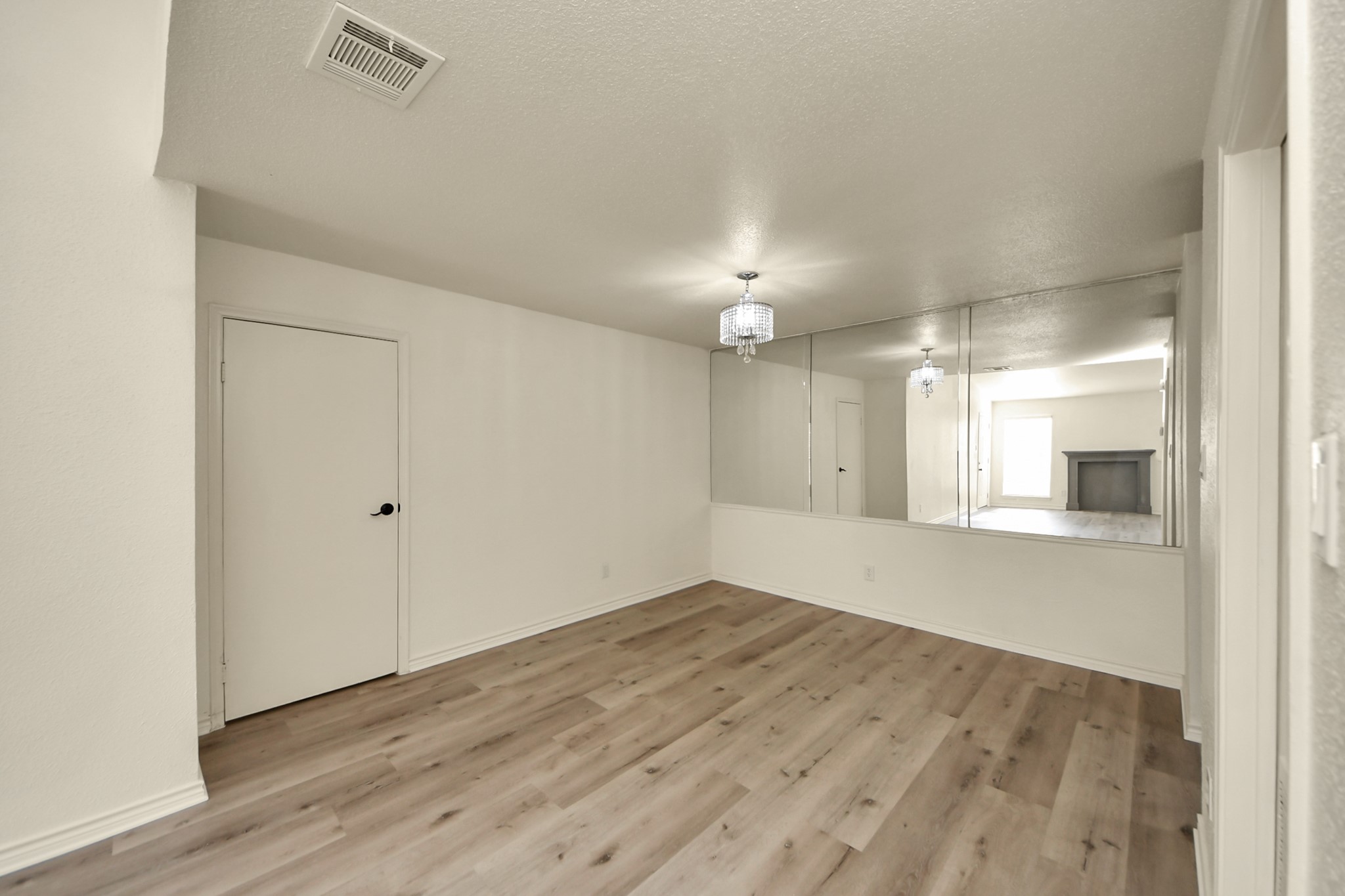 6500 Sands Point Drive, Unit 804 Houston, TX 77074 - Photo 13 of 40 an empty room with wooden floor and mirror