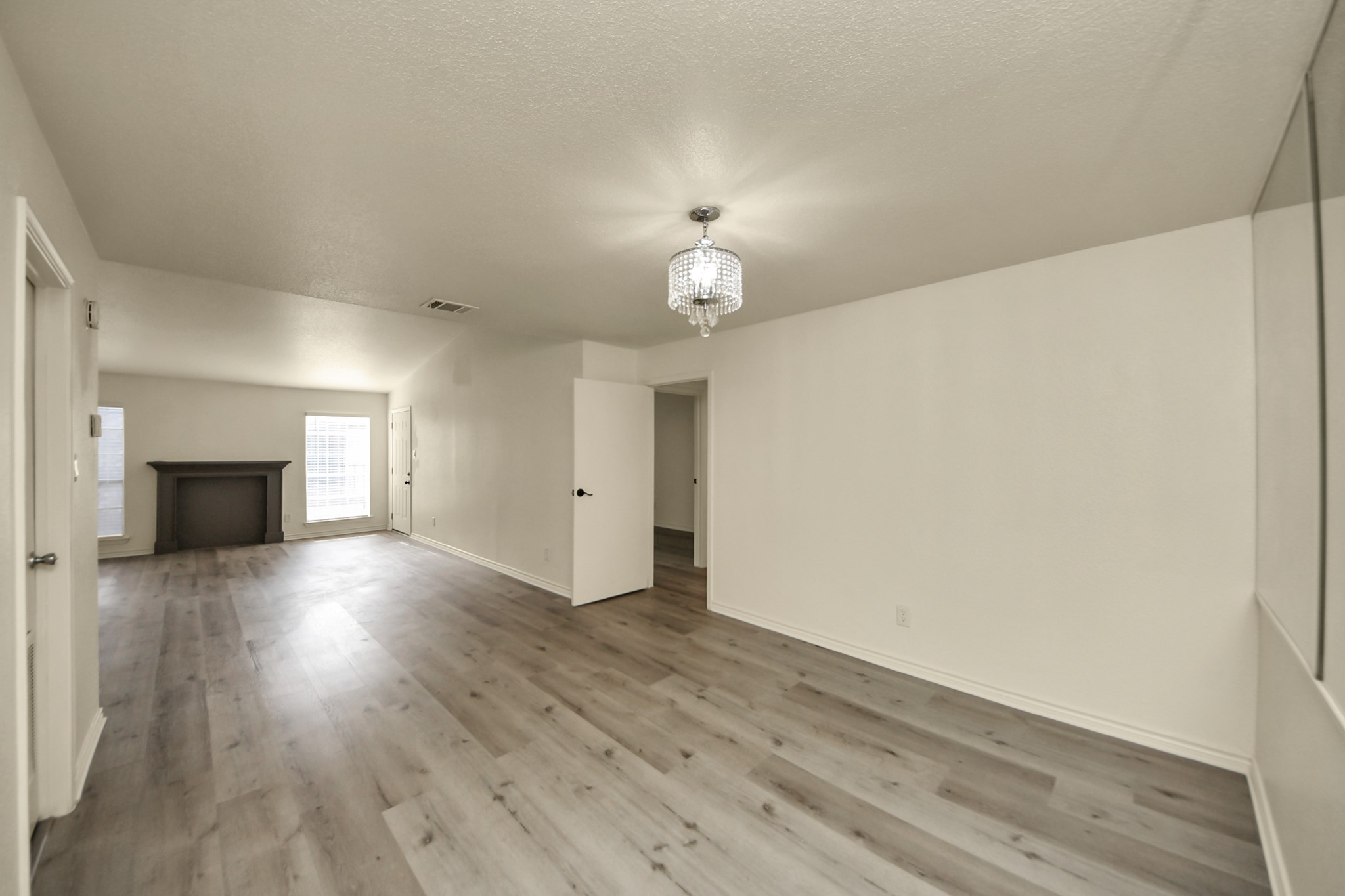 6500 Sands Point Drive, Unit 804 Houston, TX 77074 - Photo 14 of 40 an empty room with wooden floor and fireplace