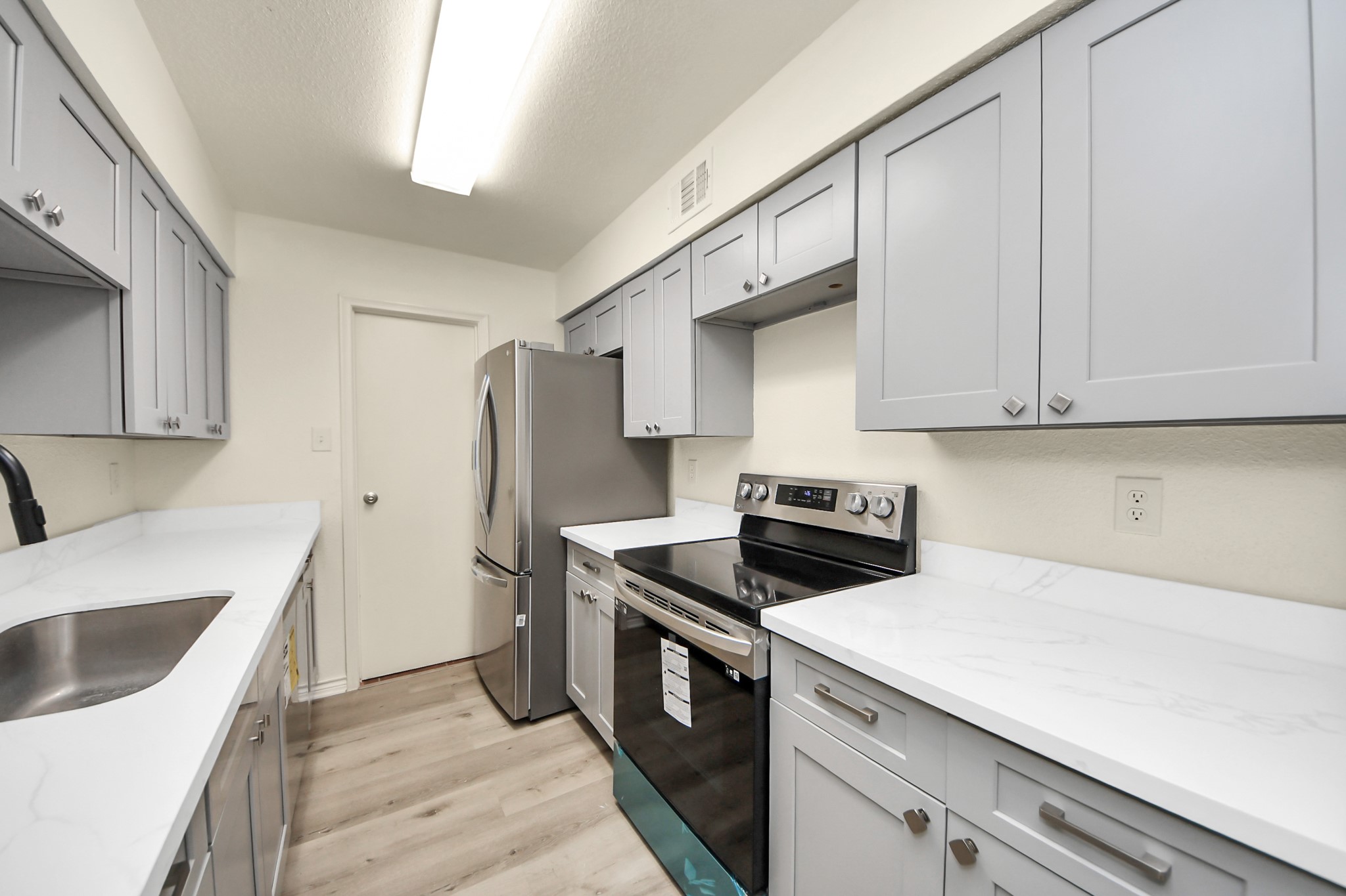 6500 Sands Point Drive, Unit 804 Houston, TX 77074 - Photo 15 of 40 a kitchen with stainless steel appliances granite countertop a sink stove and refrigerator