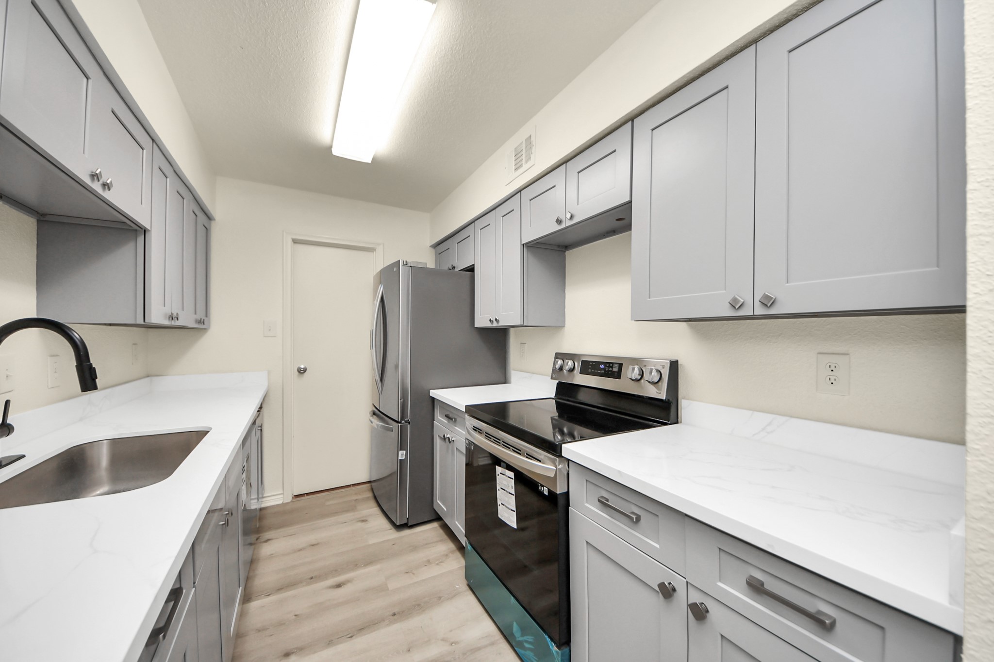 6500 Sands Point Drive, Unit 804 Houston, TX 77074 - Photo 17 of 40 a kitchen with stainless steel appliances granite countertop a sink a stove and refrigerator