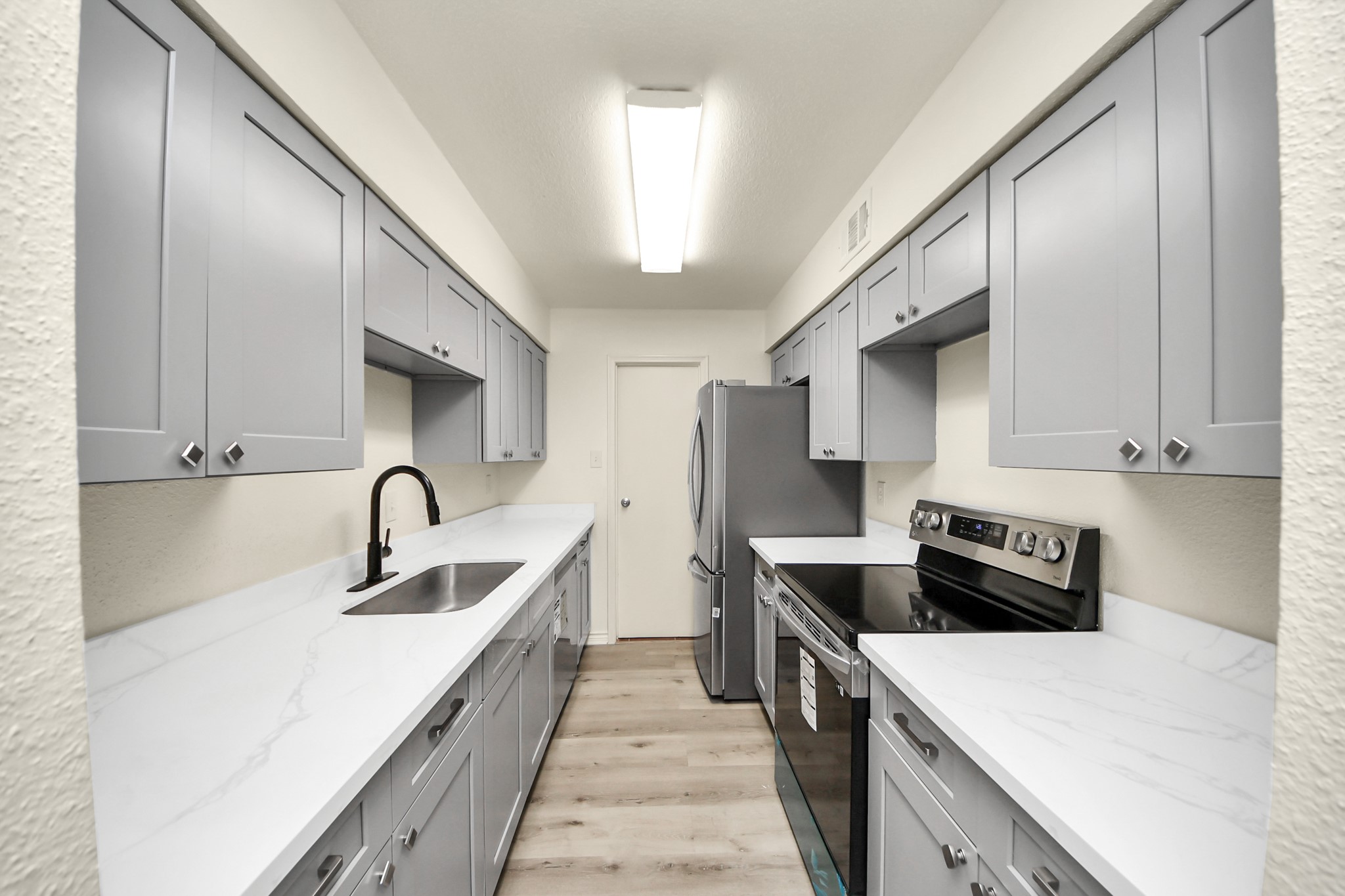6500 Sands Point Drive, Unit 804 Houston, TX 77074 - Photo 2 of 40 a kitchen with a sink a stove and refrigerator