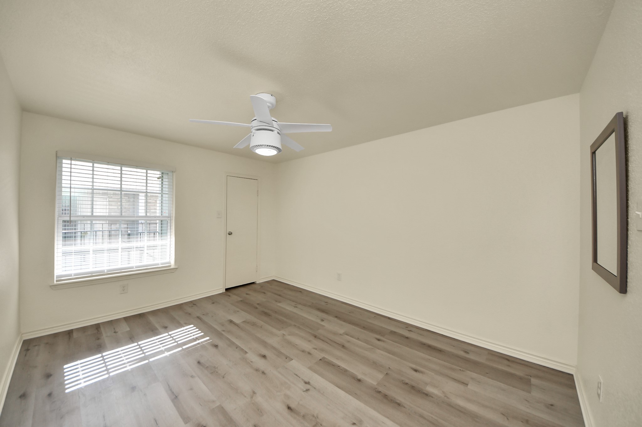 6500 Sands Point Drive, Unit 804 Houston, TX 77074 - Photo 22 of 40 an empty room with wooden floor and windows