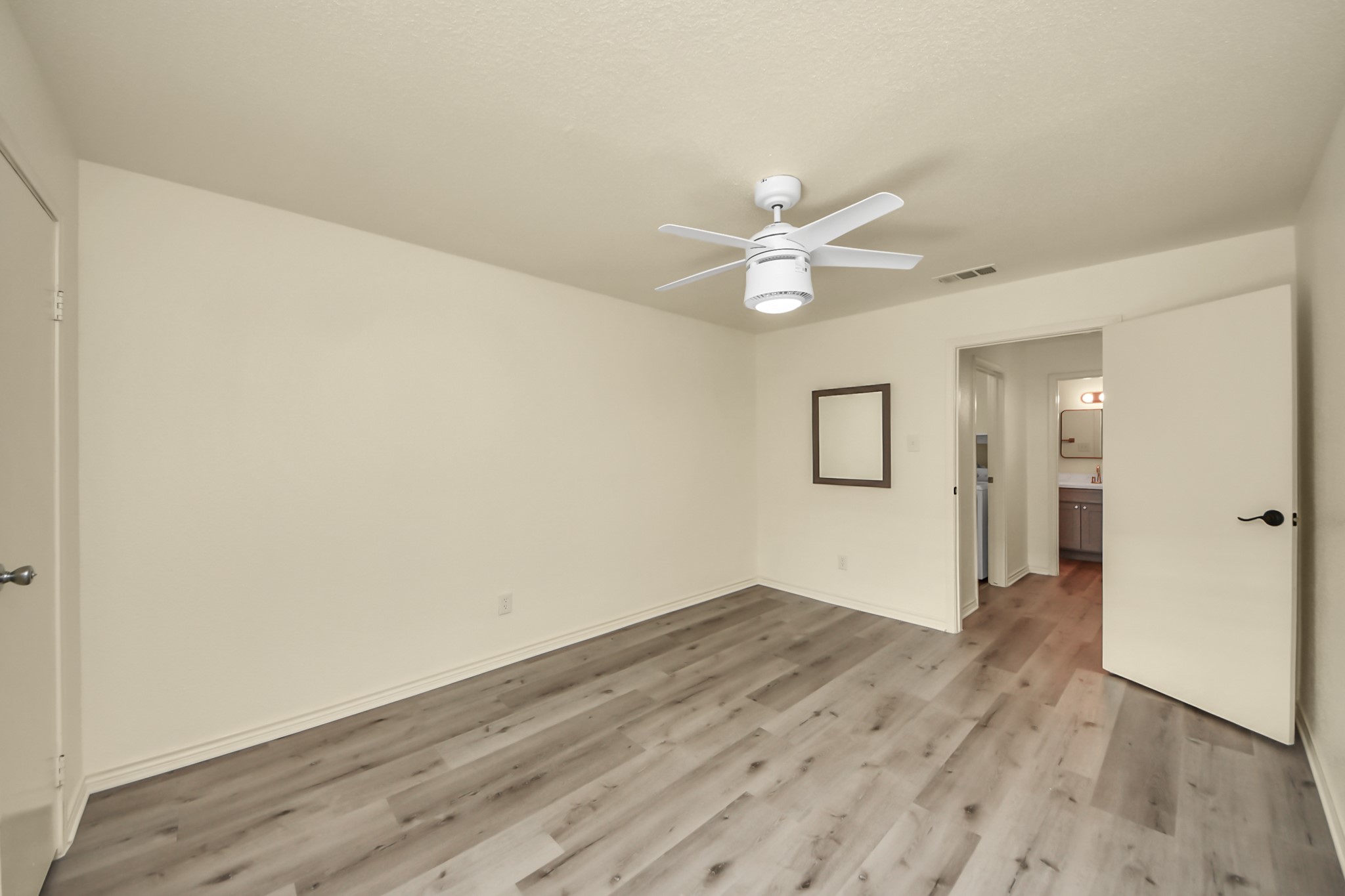 6500 Sands Point Drive, Unit 804 Houston, TX 77074 - Photo 23 of 40 an empty room with wooden floor and ceiling fan