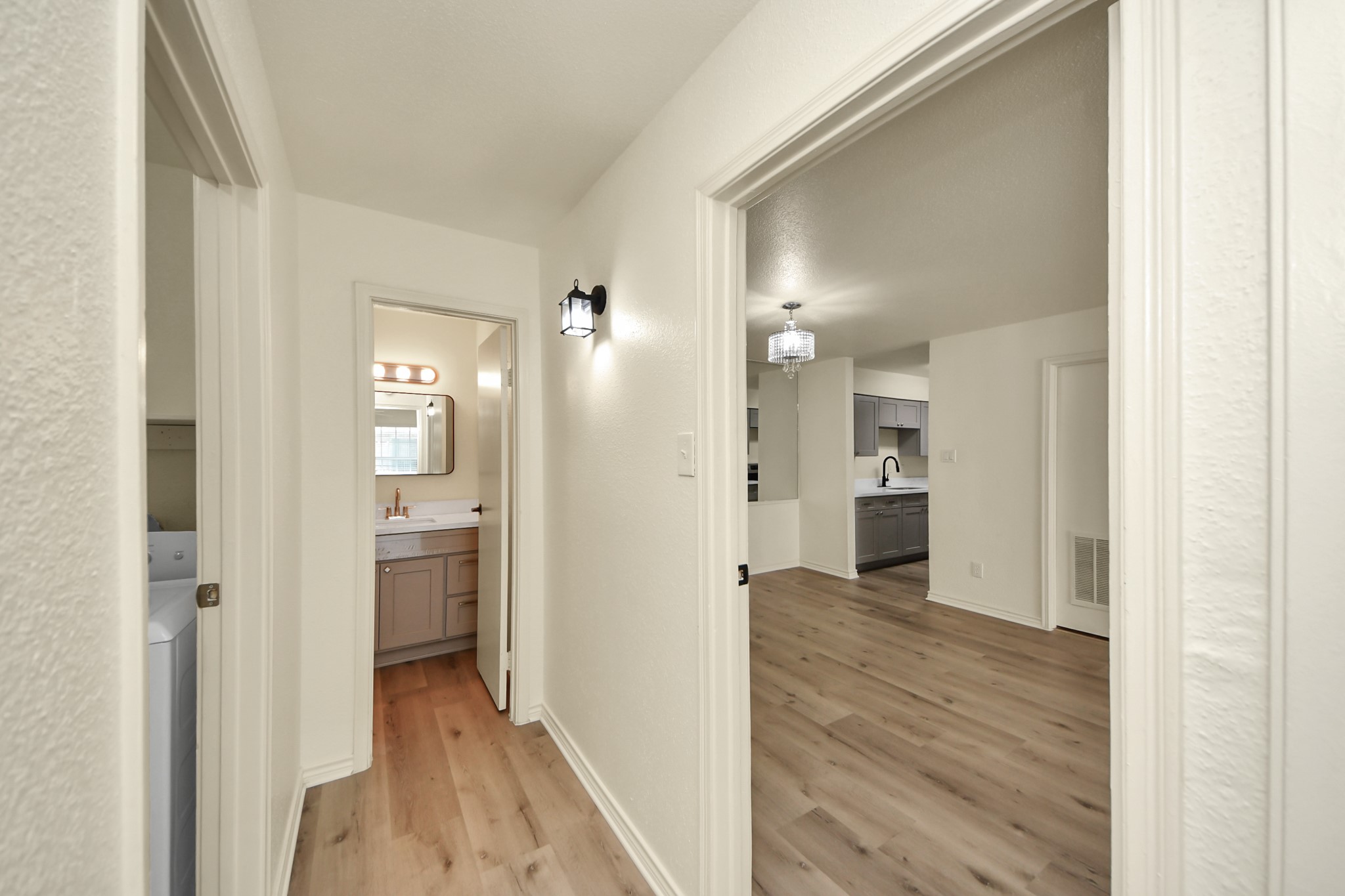 6500 Sands Point Drive, Unit 804 Houston, TX 77074 - Photo 27 of 40 a view of a hallway with wooden floor a bathroom and a sink