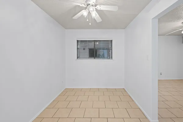 an empty room with closet and mirror