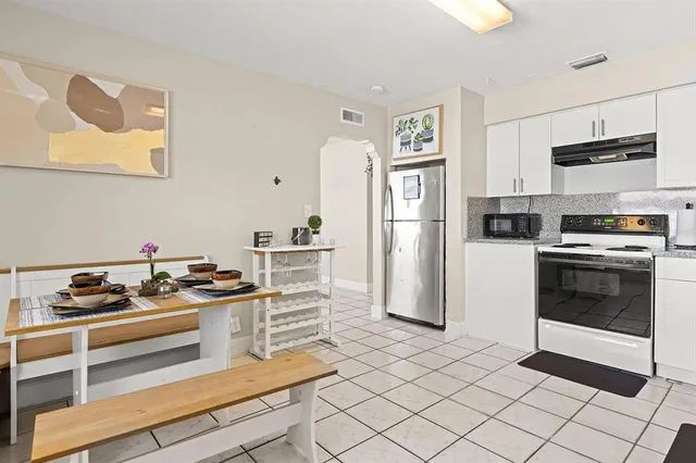 a kitchen with stainless steel appliances a stove a refrigerator and cabinets