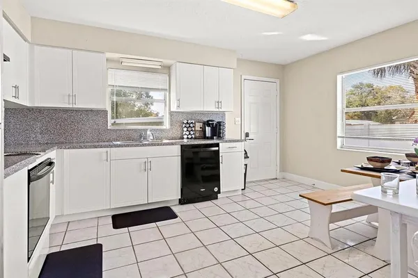 a kitchen with a stove a sink and a refrigerator