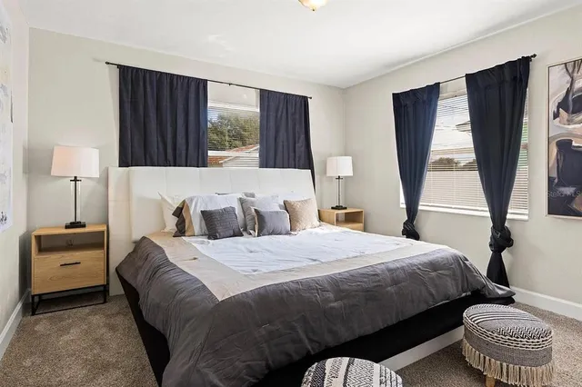 a bedroom with a bed and a couch