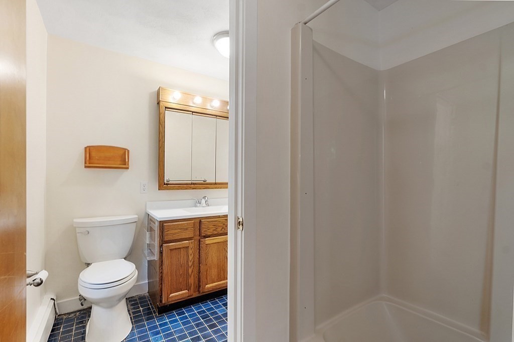 71 Mill Road Littleton, MA 01460 - Photo 11 of 30 a bathroom with a toilet a sink and bathtub