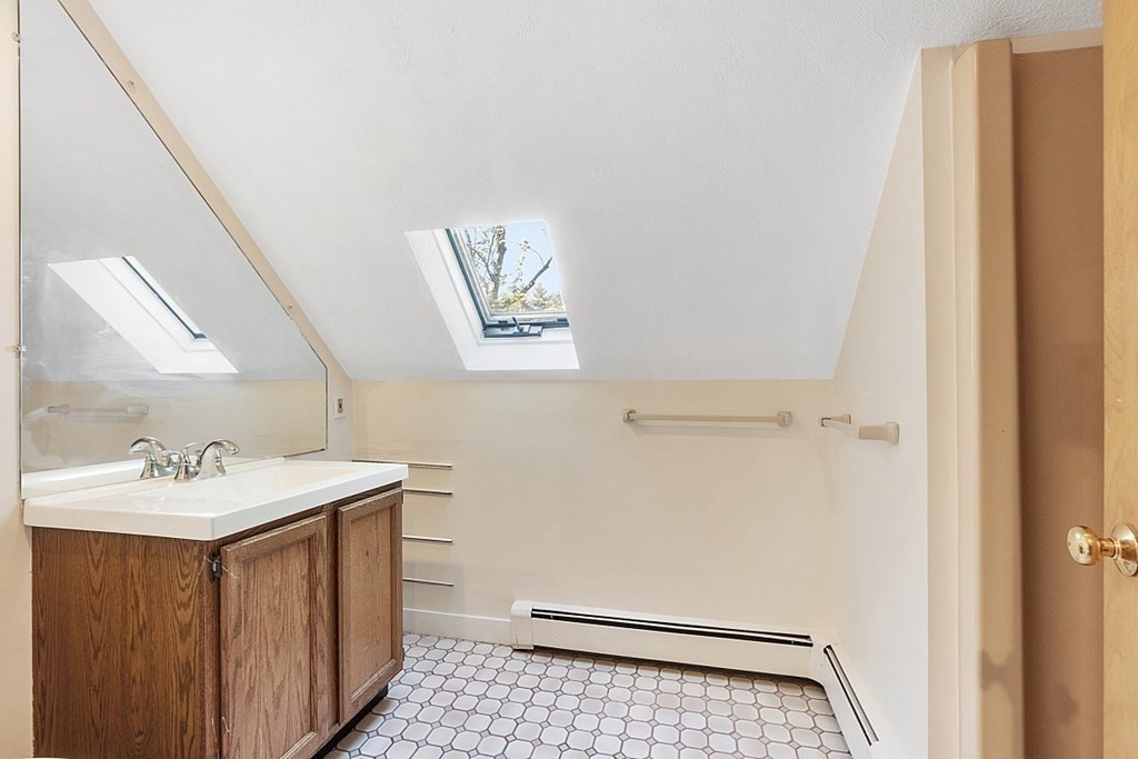 71 Mill Road Littleton, MA 01460 - Photo 20 of 30 a bathroom with a sink a toilet and mirror