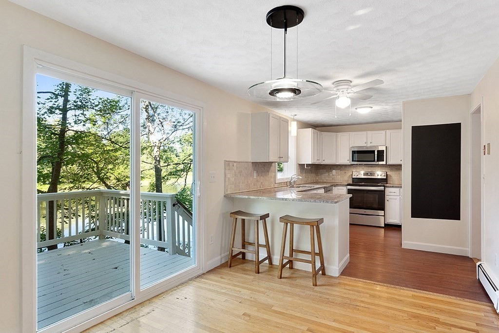 71 Mill Road Littleton, MA 01460 - Photo 3 of 30 a kitchen with stainless steel appliances granite countertop a stove and a refrigerator