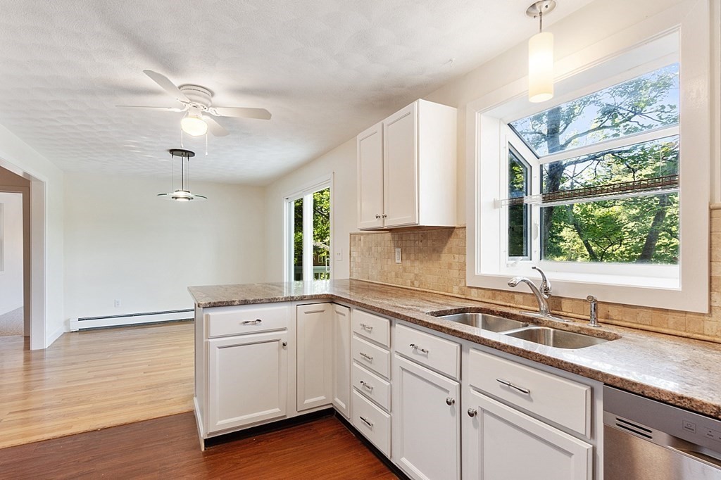 71 Mill Road Littleton, MA 01460 - Photo 6 of 30 a kitchen with a sink cabinets and window