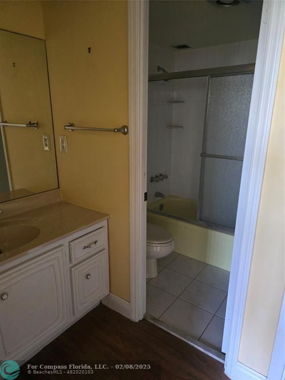 7051 Environ Boulevard, Unit 336 Lauderhill, FL 33319 - Photo 11 of 15 a bathroom with a granite countertop sink a toilet and shower