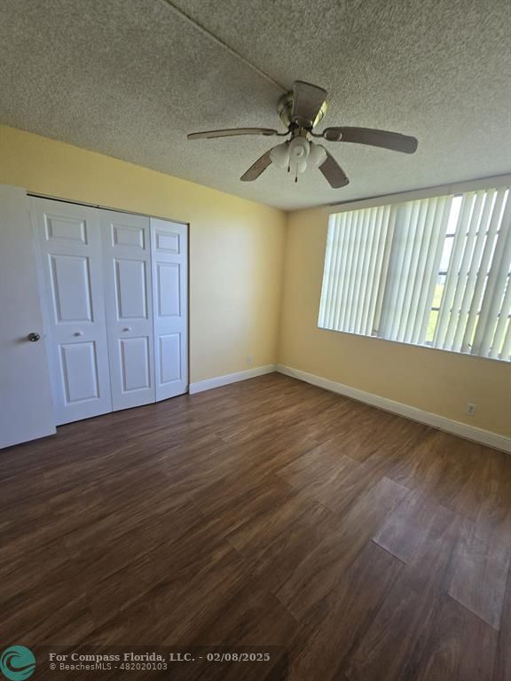 7051 Environ Boulevard, Unit 336 Lauderhill, FL 33319 - Photo 13 of 15 an empty room with wooden floor fan and windows