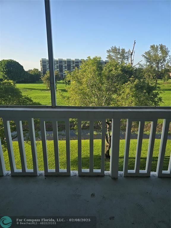 7051 Environ Boulevard, Unit 336 Lauderhill, FL 33319 - Photo 14 of 15 a view of porch with a floor to ceiling window and a yard
