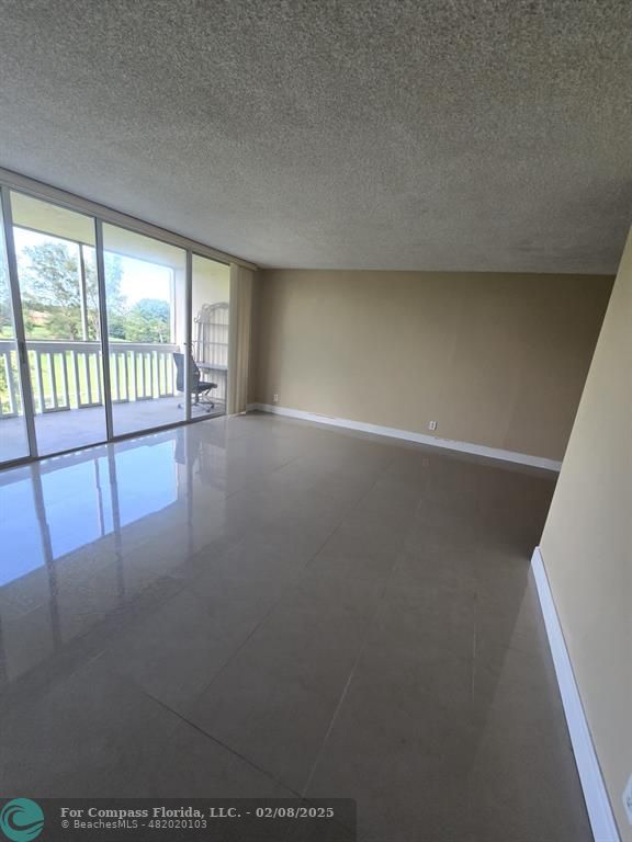 7051 Environ Boulevard, Unit 336 Lauderhill, FL 33319 - Photo 7 of 15 an empty room with windows