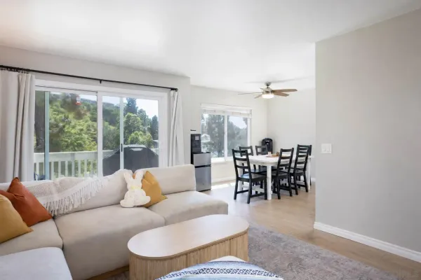 a dining room with furniture and a large window