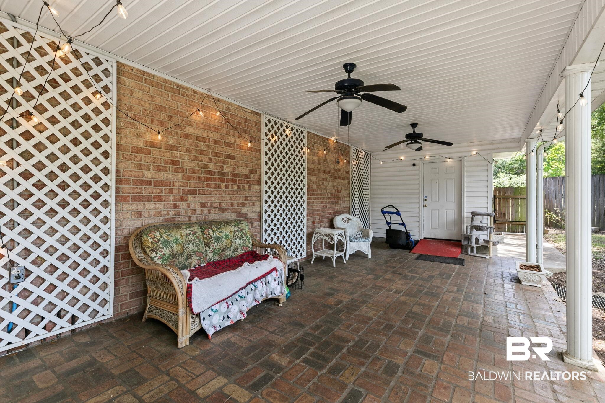 927 Cleveland Road Saraland, AL 36571 - Photo 56 of 80 Covered patio featuring brick flooring and a brick accent wall