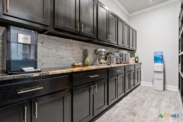 a kitchen with stainless steel appliances a sink dishwasher stove and cabinets