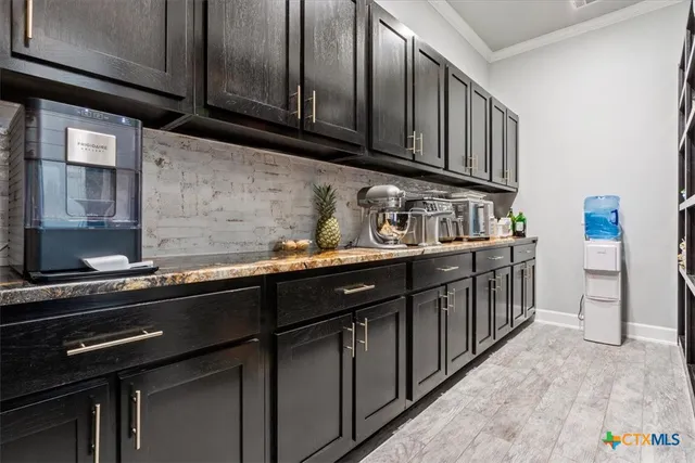 a kitchen with stainless steel appliances a sink dishwasher stove and cabinets