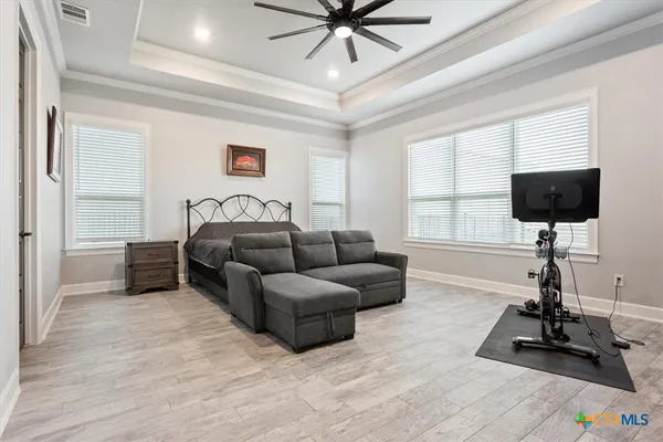 a living room with furniture a window and a flat screen tv