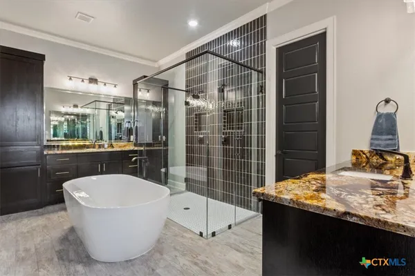 a bathroom with a granite countertop sink a toilet and shower
