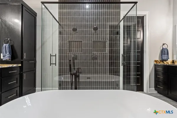 a bedroom with a bed and a mirror on dresser