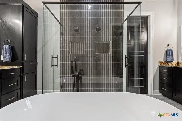 a bedroom with a bed and a mirror on dresser