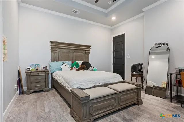 a bedroom with a bed table closet and a window