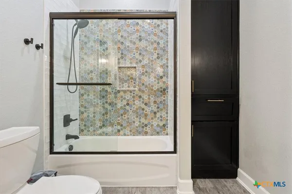 a bathroom with a shower and a toilet