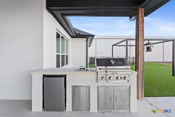 a kitchen with stainless steel appliances granite countertop a stove and a refrigerator