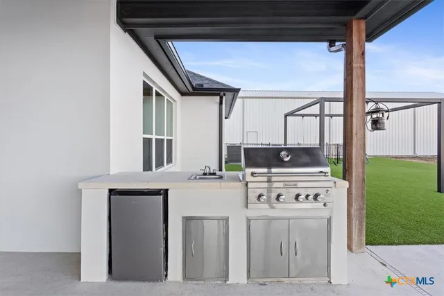 a kitchen with stainless steel appliances granite countertop a stove and a refrigerator