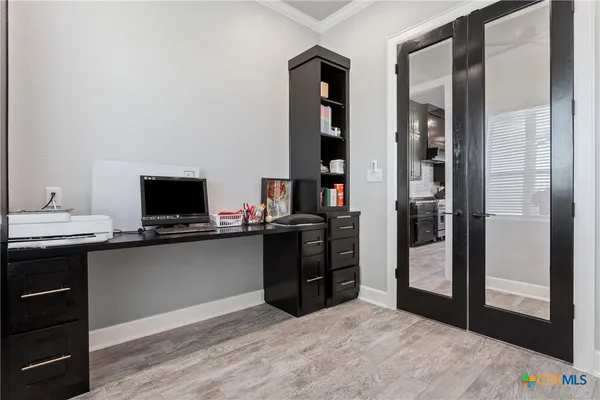 a kitchen with a refrigerator and a stove top oven