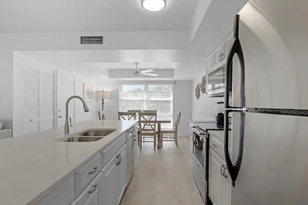 a kitchen with a refrigerator a stove a microwave and cabinets