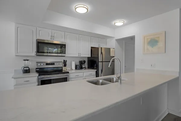 a kitchen with a table chairs microwave and cabinets