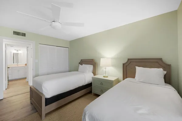 a large bedroom with a bed and flat screen tv