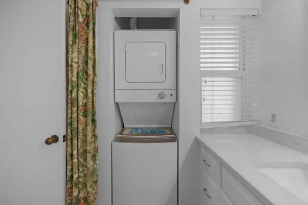 a bedroom with a bed and a view of kitchen