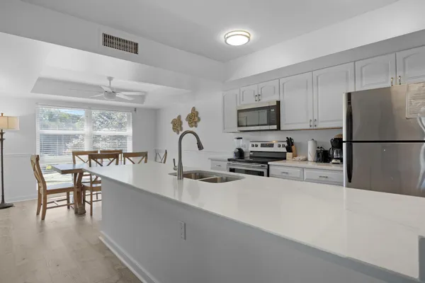 a kitchen with a refrigerator a stove a microwave and cabinets
