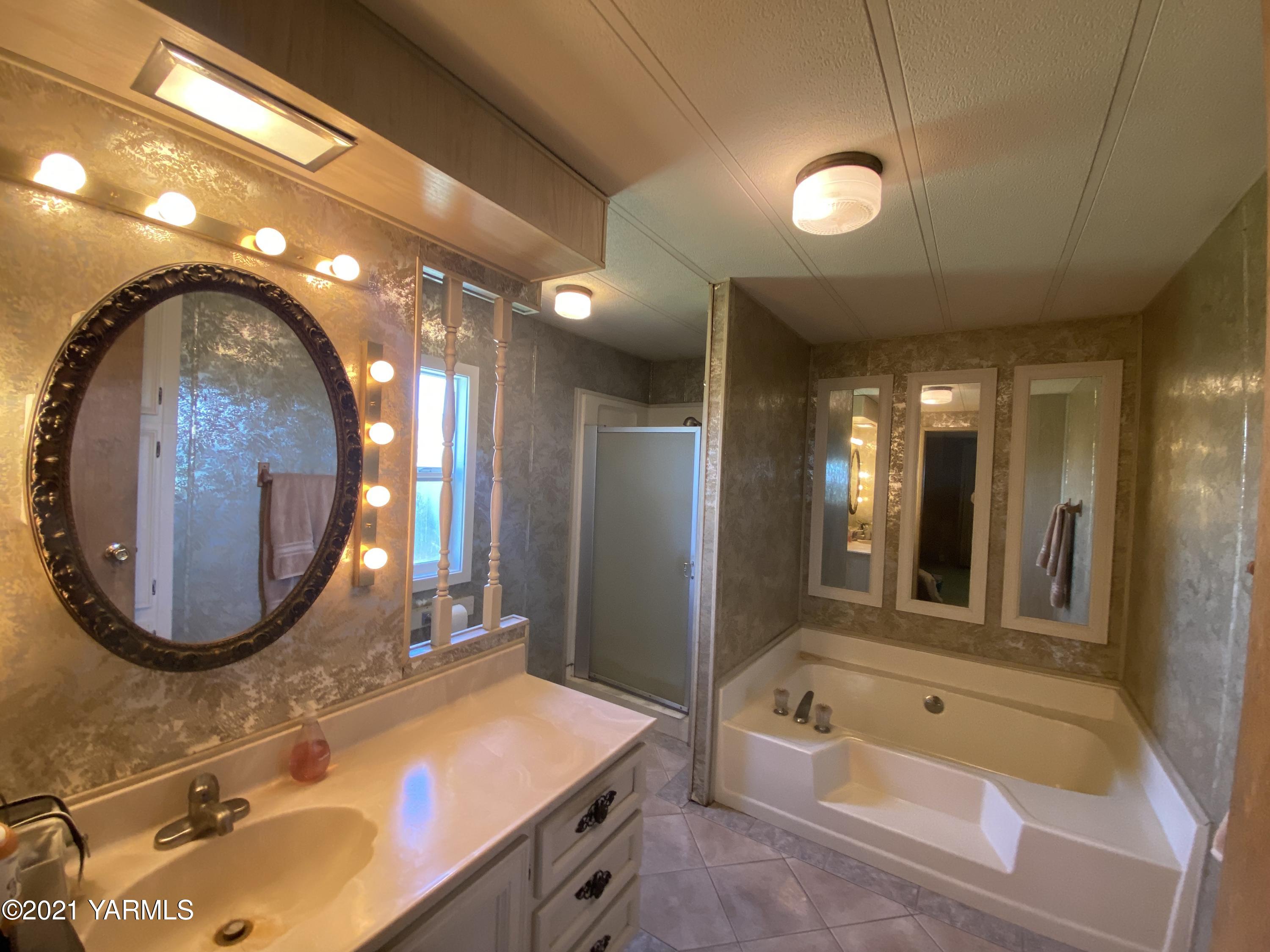 363 Riggins Road Wapato, WA 98951 - Photo 7 of 14 a bathroom with a sink mirror vanity and bathtub