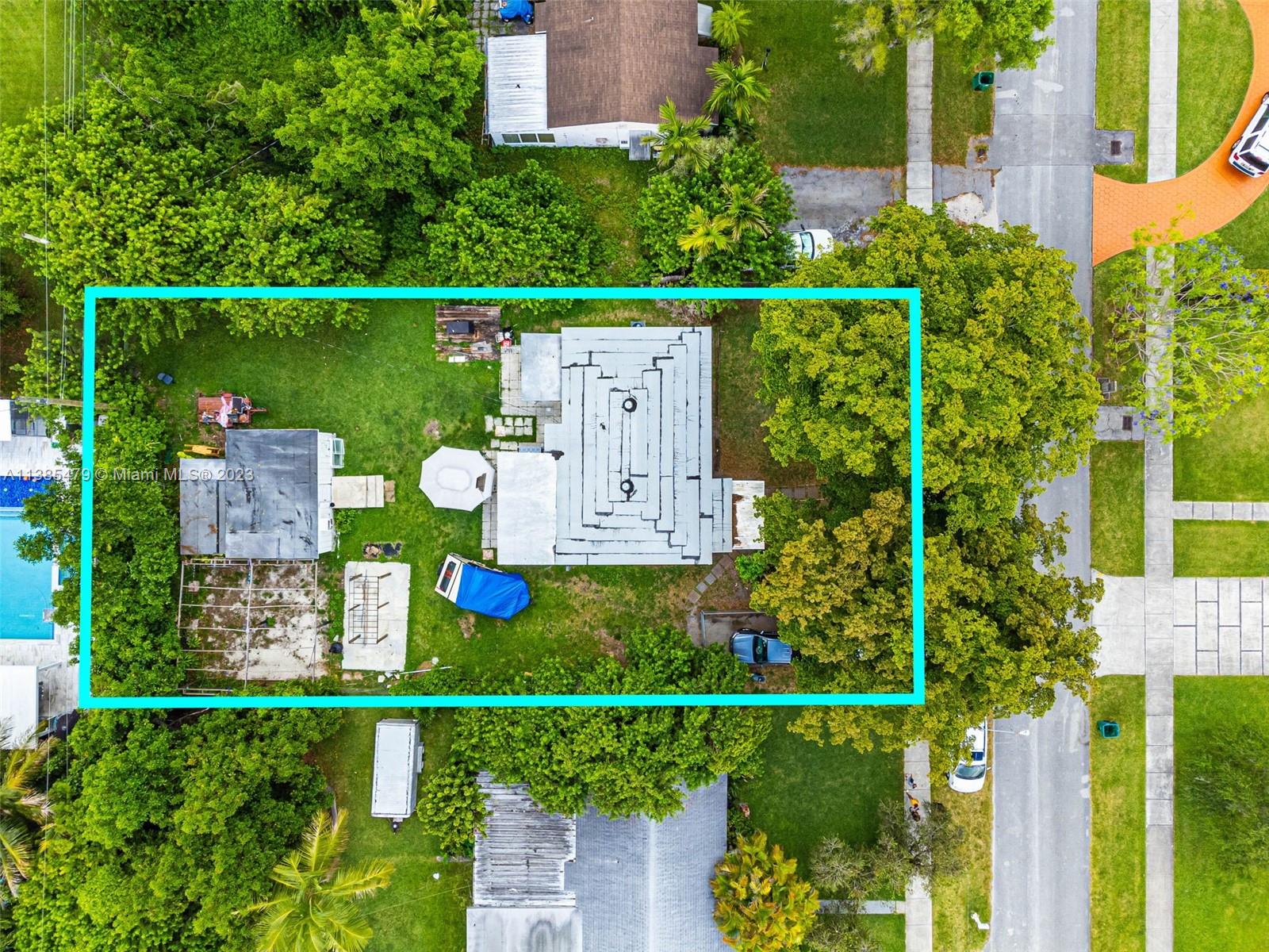 an aerial view of a house with a yard and lake view