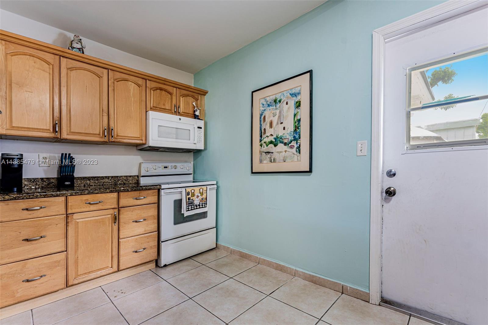 8241 Southwest 37th Street Miami, FL 33155 - Photo 11 of 46 a kitchen with stainless steel appliances granite countertop a stove and a refrigerator