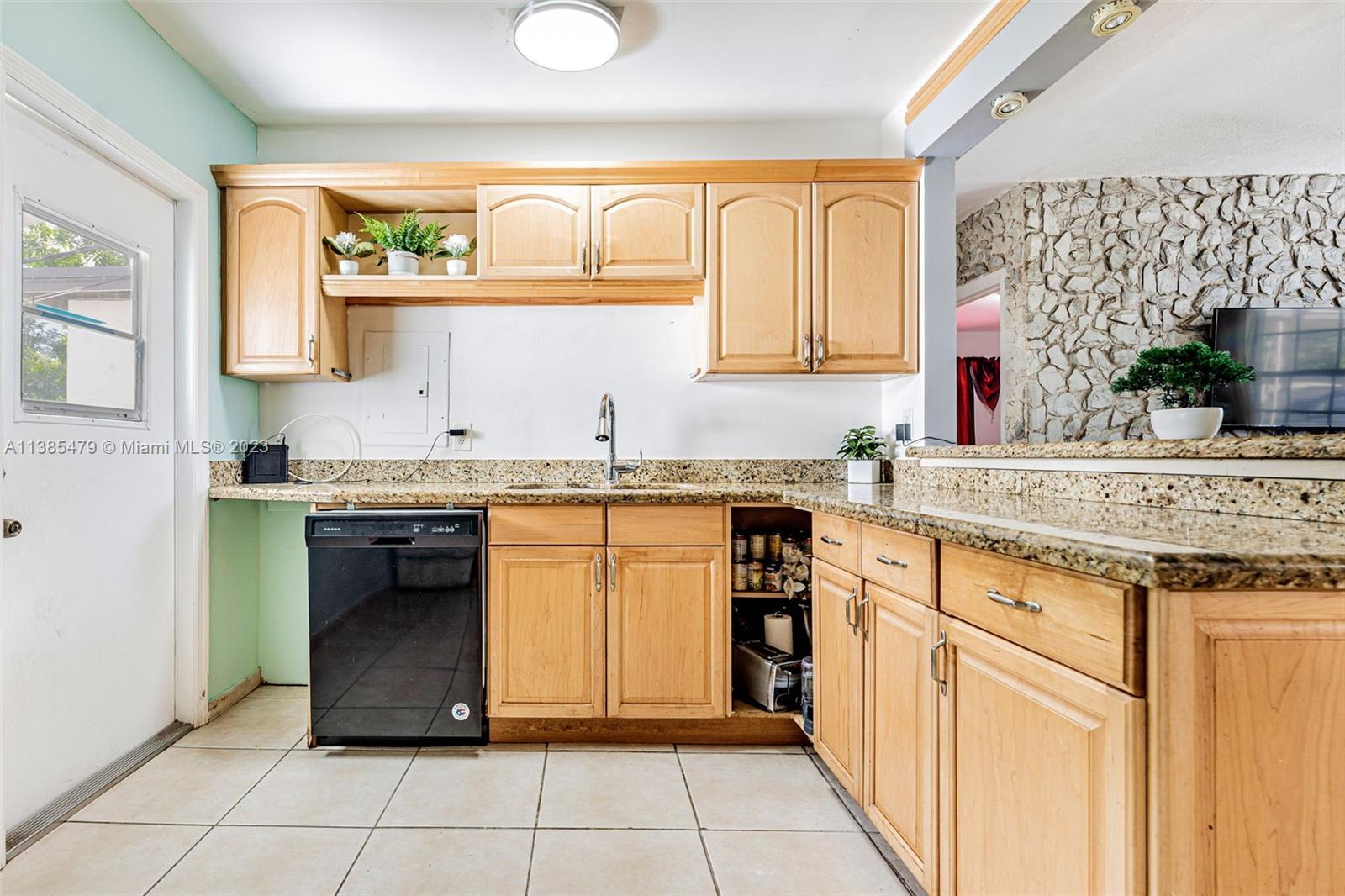8241 Southwest 37th Street Miami, FL 33155 - Photo 12 of 46 a kitchen with granite countertop a sink and a stove