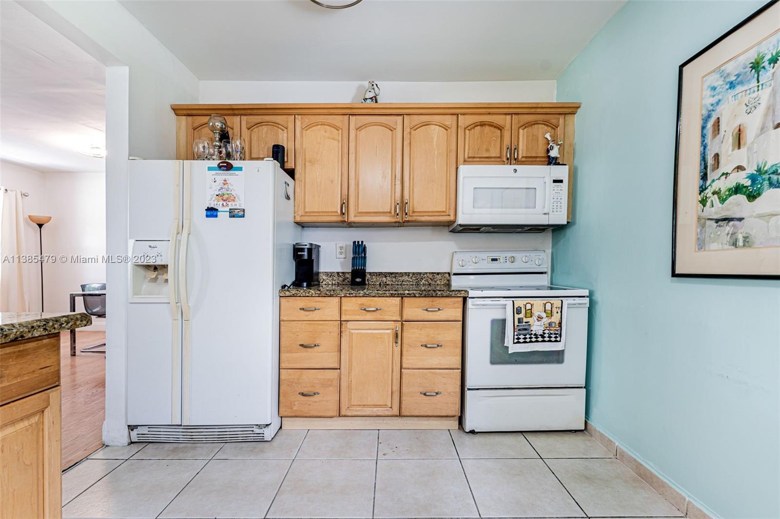 8241 Southwest 37th Street Miami, FL 33155 - Photo 13 of 46 a kitchen with stainless steel appliances a refrigerator and cabinets