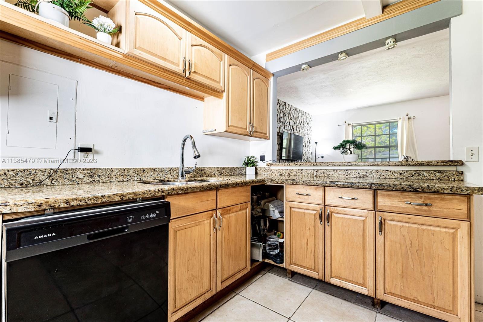 8241 Southwest 37th Street Miami, FL 33155 - Photo 14 of 46 a kitchen with granite countertop cabinets stainless steel appliances and a counter space