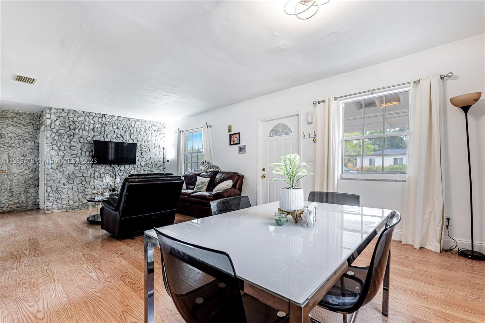 8241 Southwest 37th Street Miami, FL 33155 - Photo 15 of 46 a living room with furniture a flat screen tv and a window