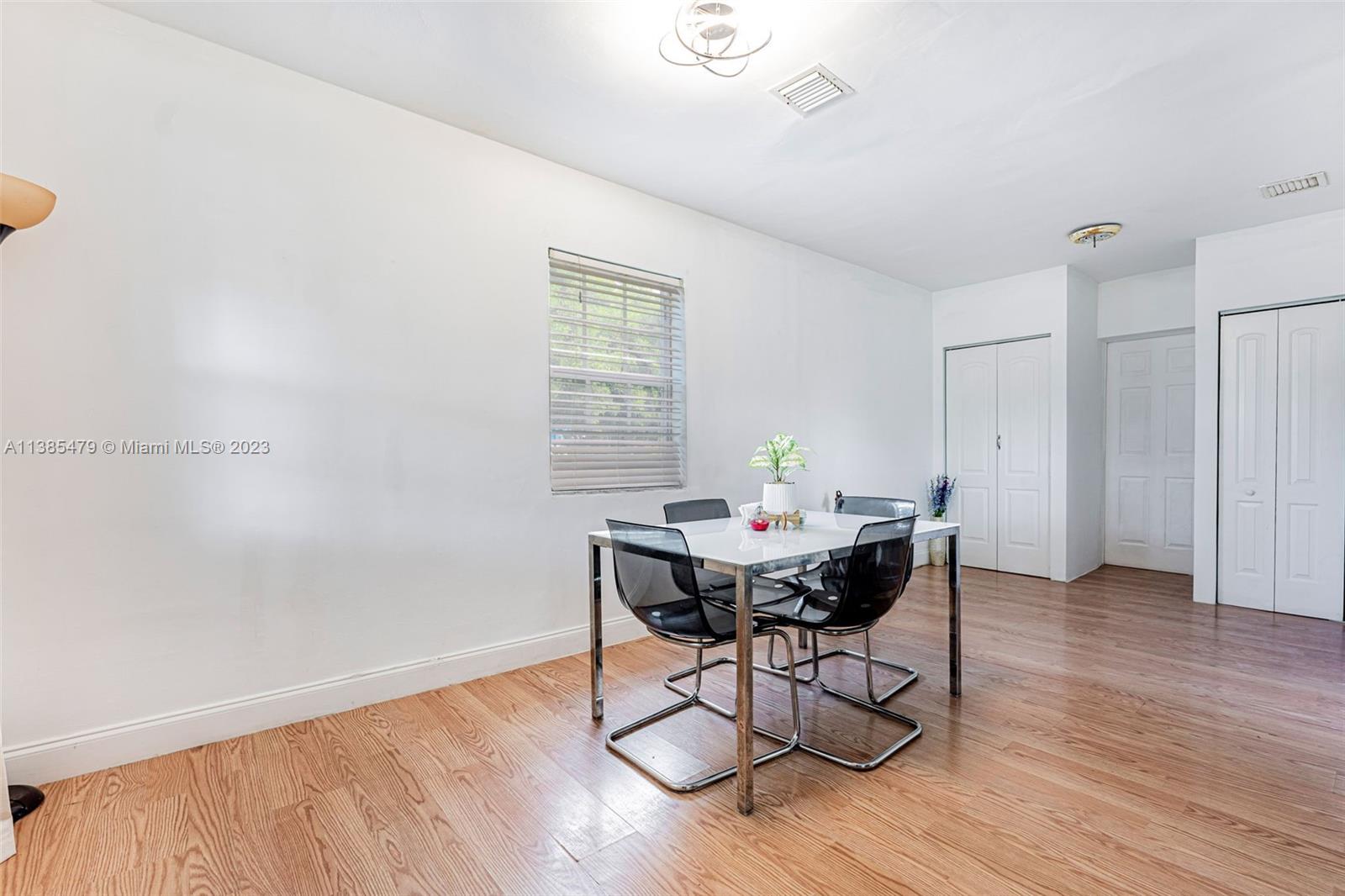 8241 Southwest 37th Street Miami, FL 33155 - Photo 16 of 46 a view of a dining room with furniture and wooden floor